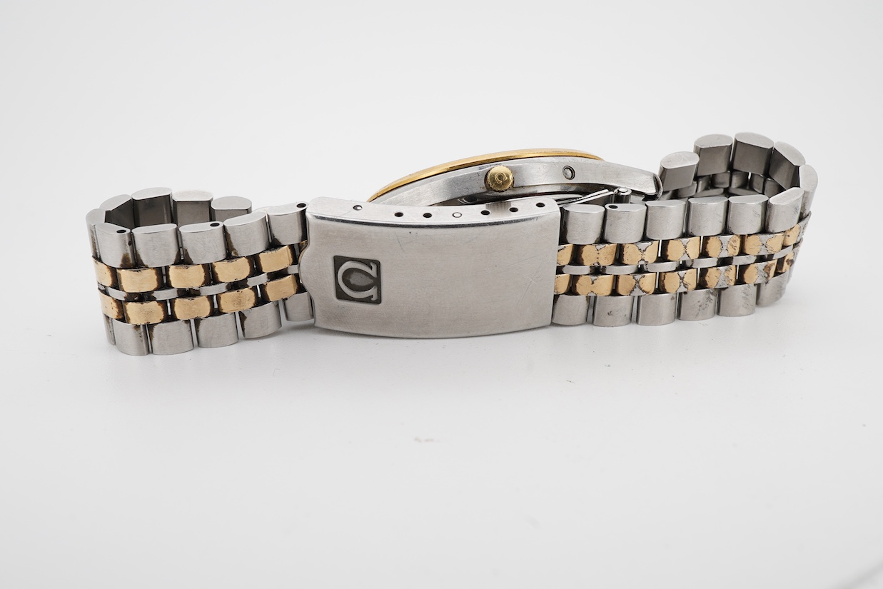 A gentleman's early 1980's stainless steel and gold plated Omega Seamaster quartz wrist watch, with baton numerals and date aperture, movement c.1337, case diameter 34mm, on a steel and gold plated Omega bracelet, with s